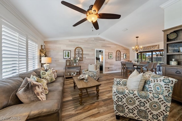 living room featuring wood walls, vaulted ceiling, ceiling fan with notable chandelier, ornamental molding, and dark hardwood / wood-style flooring