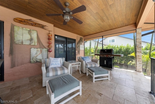 sunroom / solarium with plenty of natural light, ceiling fan, and wood ceiling