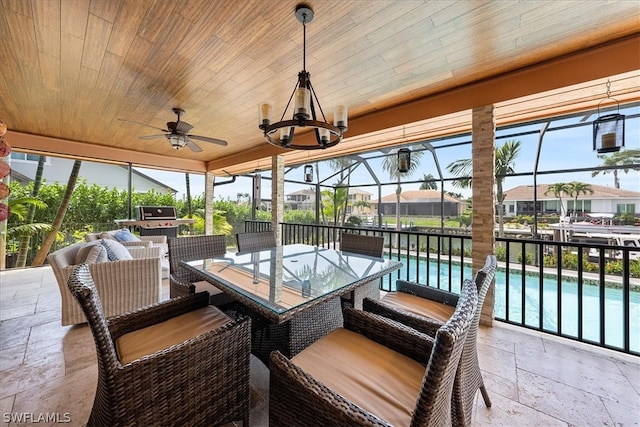 sunroom featuring wood ceiling and ceiling fan with notable chandelier