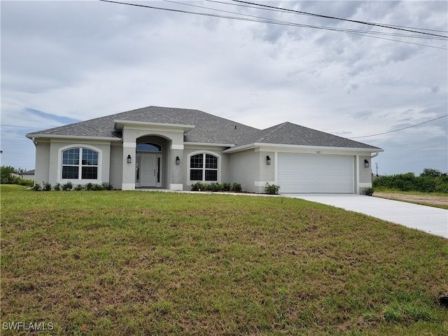 view of front facade with a front yard and a garage