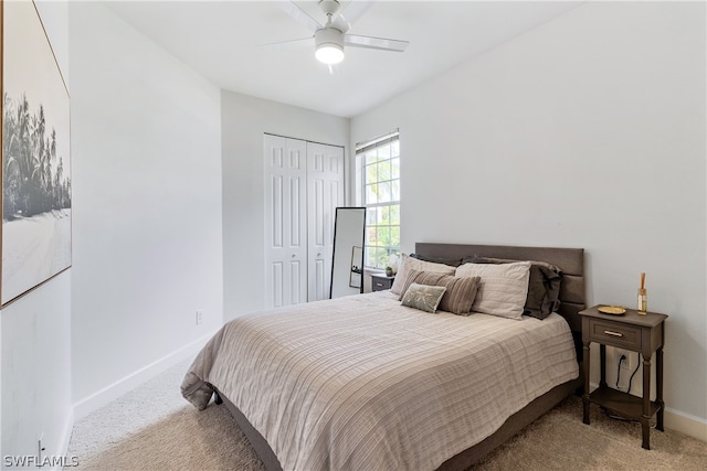 carpeted bedroom with ceiling fan and a closet