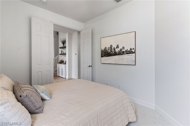 bedroom featuring light carpet