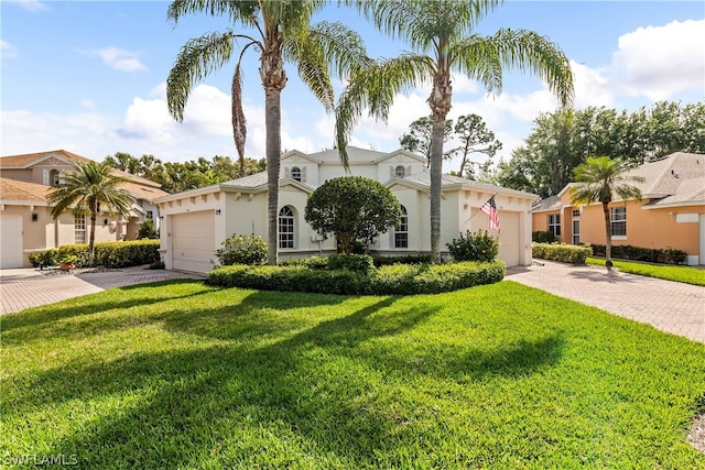 ranch-style home with a front lawn and a garage