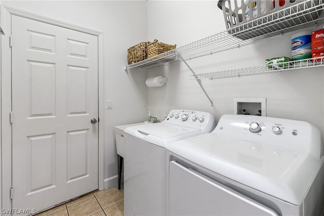 laundry area with light tile floors, washer and dryer, and hookup for a washing machine