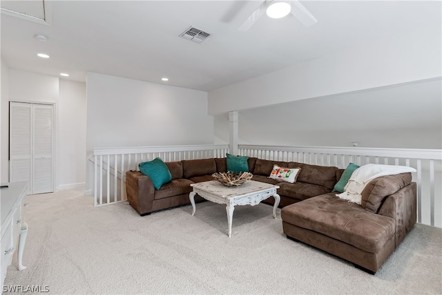 living room with ceiling fan and light colored carpet