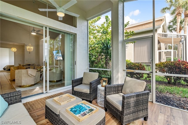 sunroom / solarium featuring ceiling fan and outdoor lounge area