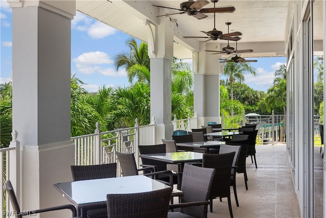 view of patio featuring ceiling fan and a balcony