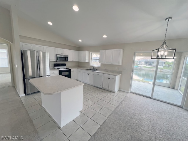 kitchen with sink, stainless steel appliances, white cabinets, a center island, and plenty of natural light