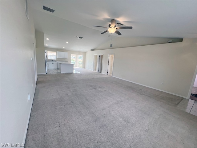 unfurnished living room with light carpet, vaulted ceiling, and ceiling fan