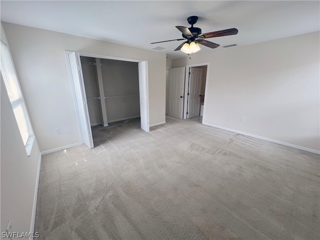 unfurnished bedroom with a closet, ceiling fan, and light colored carpet