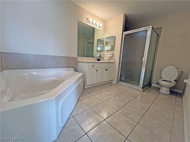 full bathroom featuring vanity, tile floors, toilet, and separate shower and tub