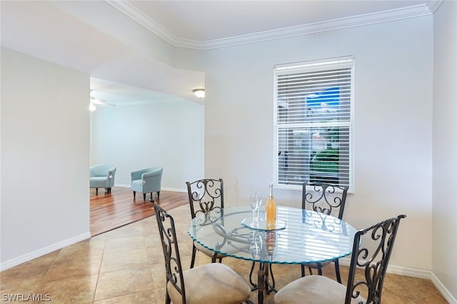 dining area with light tile patterned flooring and crown molding