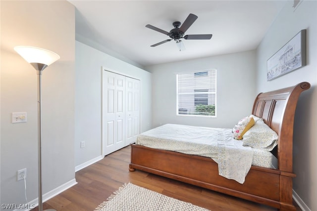 bedroom with hardwood / wood-style floors, ceiling fan, and a closet