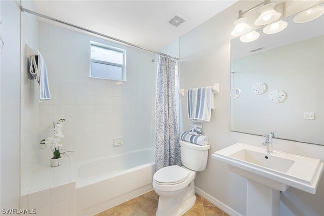 bathroom featuring toilet, shower / bathtub combination with curtain, and tile patterned flooring