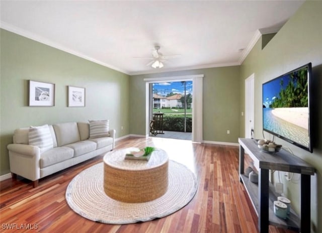 living room featuring hardwood / wood-style floors, crown molding, and ceiling fan