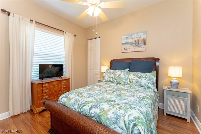 bedroom with a closet, ceiling fan, and light hardwood / wood-style flooring