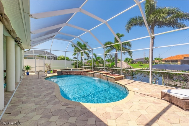 view of swimming pool featuring a patio area, an in ground hot tub, pool water feature, and a lanai