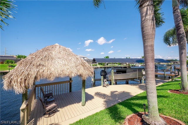 view of dock featuring a lawn and a water view