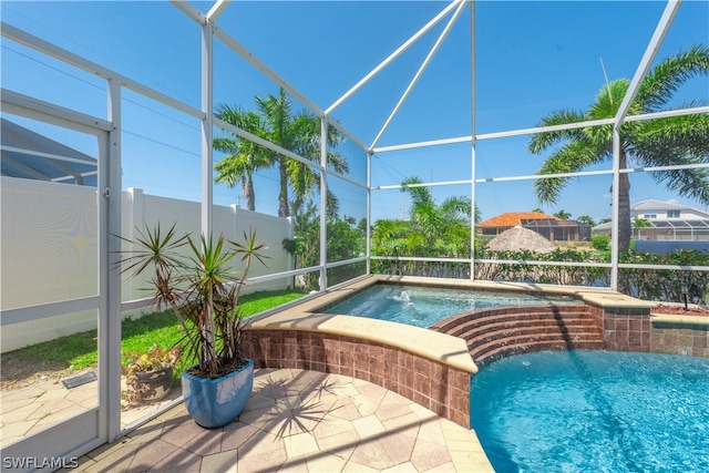 view of pool featuring a patio area, a lanai, and pool water feature