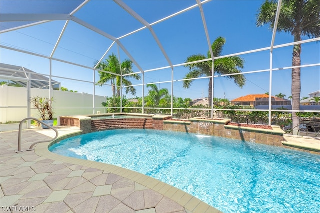 view of pool with a patio, a lanai, and pool water feature