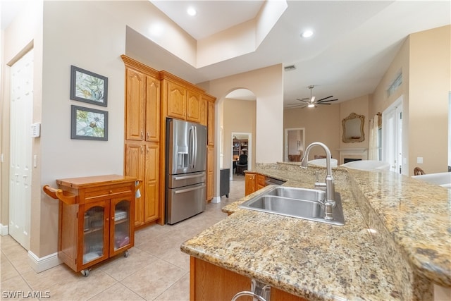 kitchen with light tile floors, stainless steel fridge with ice dispenser, ceiling fan, and sink