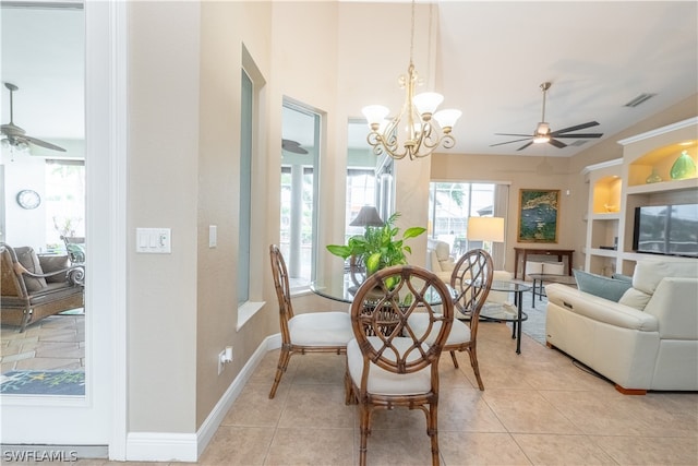 tiled dining area featuring ceiling fan with notable chandelier