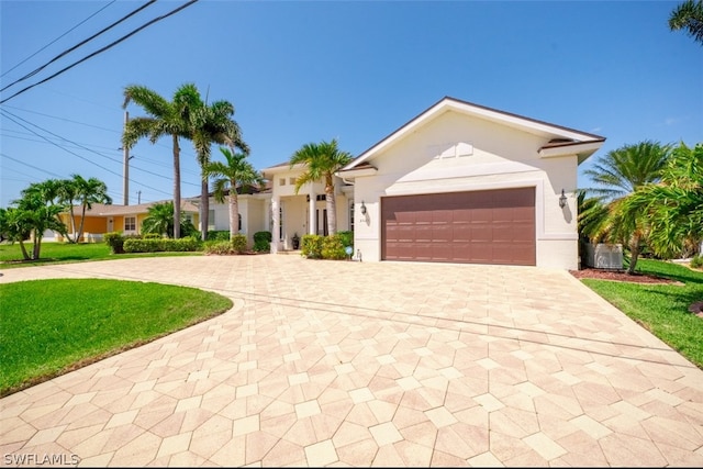 single story home with a front yard and a garage