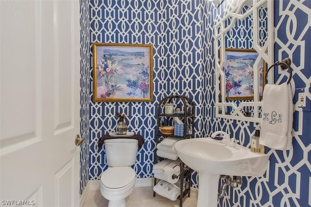 bathroom with toilet and tile patterned floors