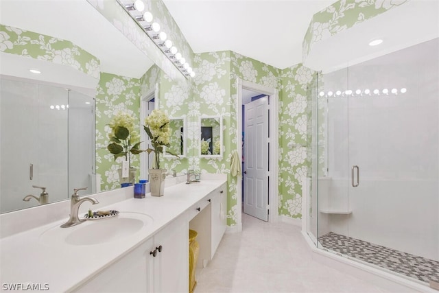 bathroom featuring tile patterned floors, a shower with door, and vanity