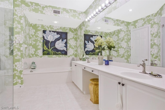 bathroom with a bathing tub, tile patterned floors, and vanity