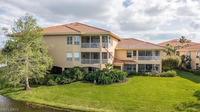 rear view of property with a yard