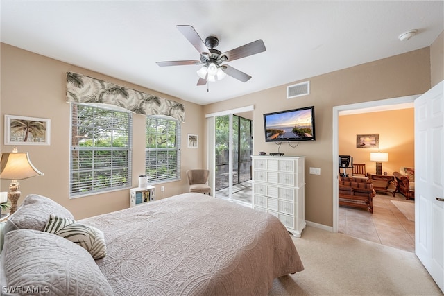 bedroom featuring light carpet, access to exterior, and ceiling fan