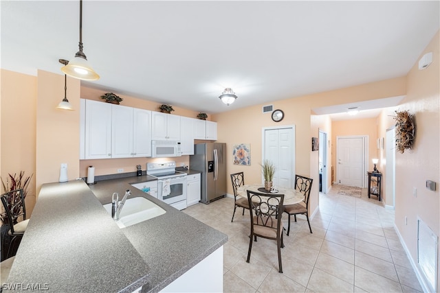 kitchen with white cabinetry, white appliances, sink, light tile floors, and pendant lighting