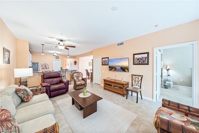 tiled living room featuring ceiling fan