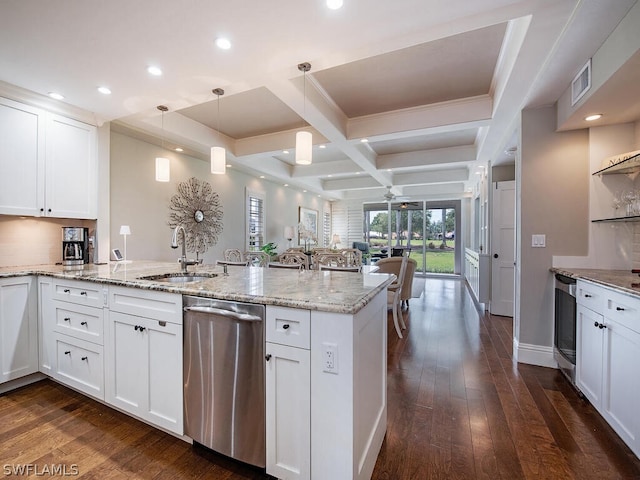 kitchen with coffered ceiling, stainless steel dishwasher, white cabinetry, and hanging light fixtures