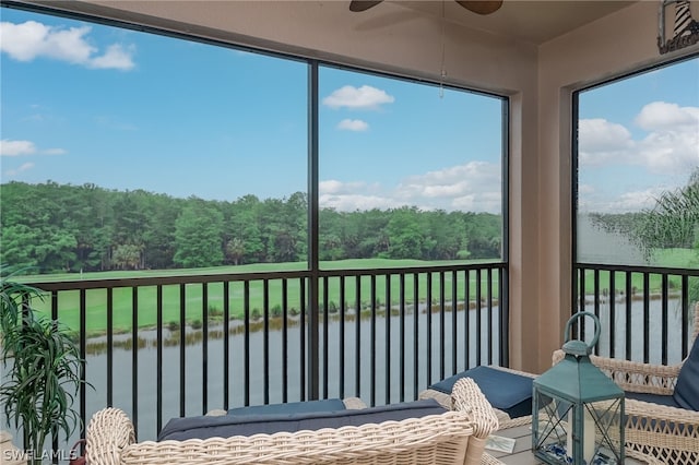 sunroom / solarium featuring ceiling fan