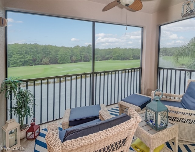 sunroom / solarium featuring ceiling fan