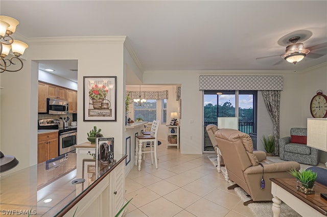 tiled living room featuring ornamental molding and ceiling fan with notable chandelier