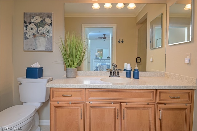 bathroom with toilet, ornamental molding, ceiling fan, and large vanity