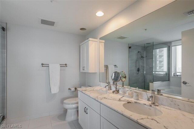 full bathroom featuring toilet, tile patterned floors, separate shower and tub, and double sink vanity