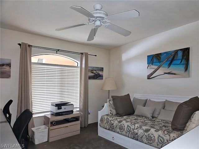 bedroom featuring ceiling fan and dark colored carpet