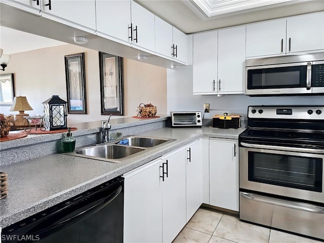 kitchen featuring sink, white cabinetry, light tile patterned floors, and appliances with stainless steel finishes