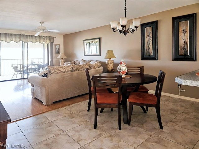 dining room with ceiling fan with notable chandelier and light tile patterned floors