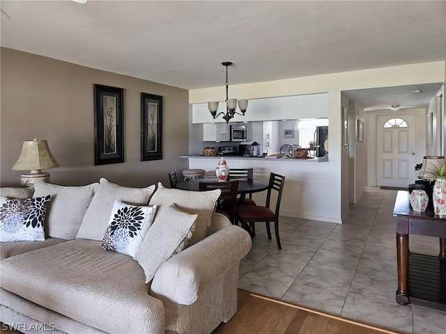 living room featuring light hardwood / wood-style flooring and a notable chandelier