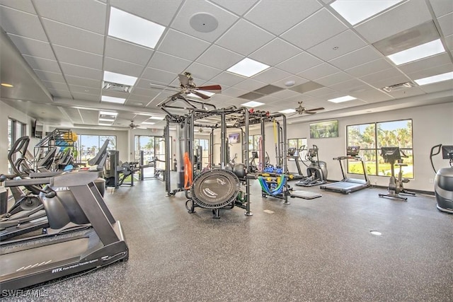 exercise room featuring a drop ceiling and ceiling fan