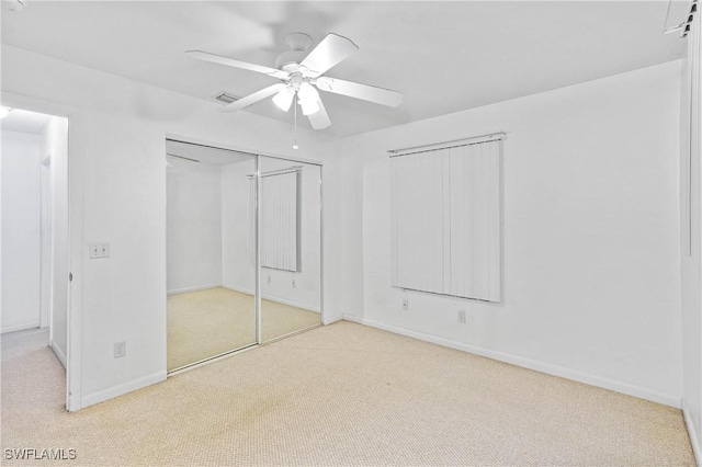 unfurnished bedroom with light carpet and ceiling fan