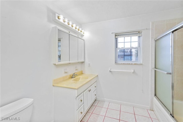 full bathroom featuring tile patterned floors, vanity, bath / shower combo with glass door, and toilet