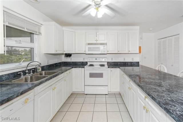 kitchen with white cabinetry, sink, and white appliances