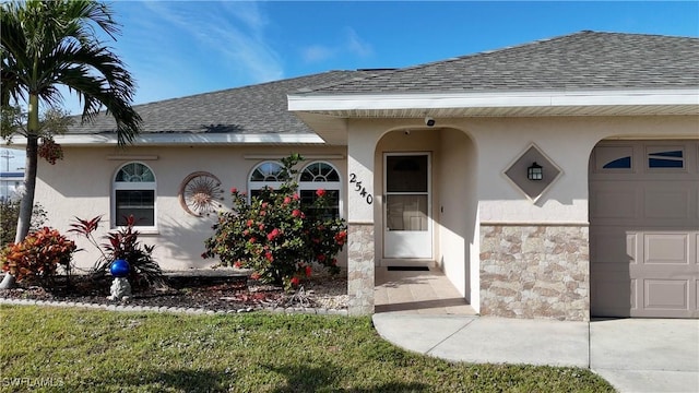 view of exterior entry with a garage