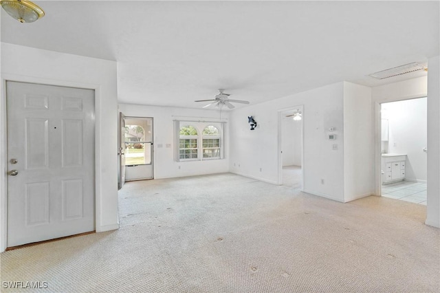 unfurnished living room with ceiling fan and light colored carpet